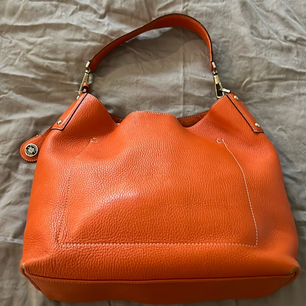 Dooney & Burke pebbled leather shoulder bag. Good condition, cloth bag included.